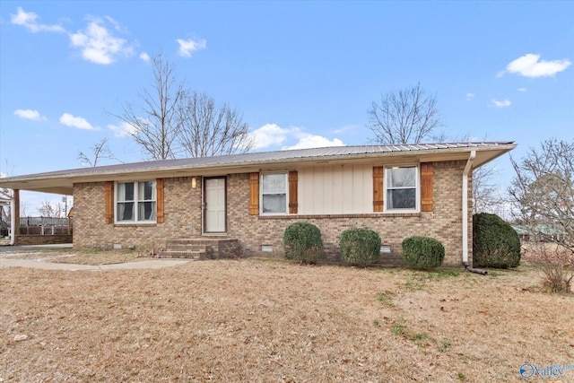 ranch-style house with crawl space, metal roof, a carport, and brick siding