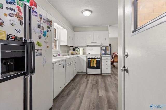 kitchen with light wood finished floors, light countertops, white cabinetry, a textured ceiling, and white appliances