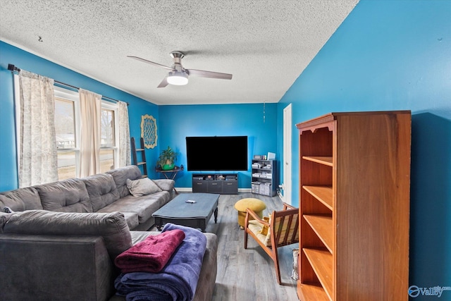 living room featuring a textured ceiling, wood finished floors, and a ceiling fan