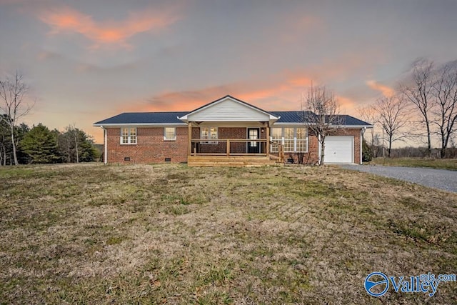 ranch-style home with brick siding, a porch, a garage, crawl space, and driveway