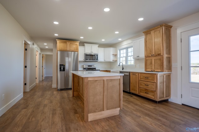 kitchen with recessed lighting, dark wood-style flooring, appliances with stainless steel finishes, and a kitchen island