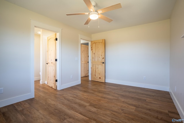 unfurnished bedroom with baseboards, a ceiling fan, and dark wood-style flooring
