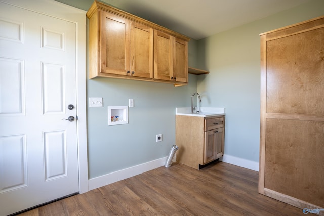 washroom featuring electric dryer hookup, dark wood-type flooring, washer hookup, cabinet space, and baseboards