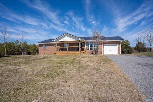 ranch-style home featuring an attached garage, covered porch, a front lawn, crawl space, and brick siding