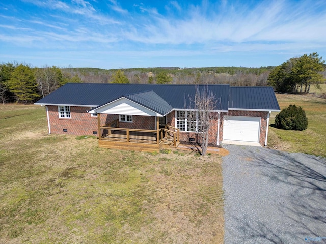 single story home with brick siding, gravel driveway, a front lawn, metal roof, and an attached garage