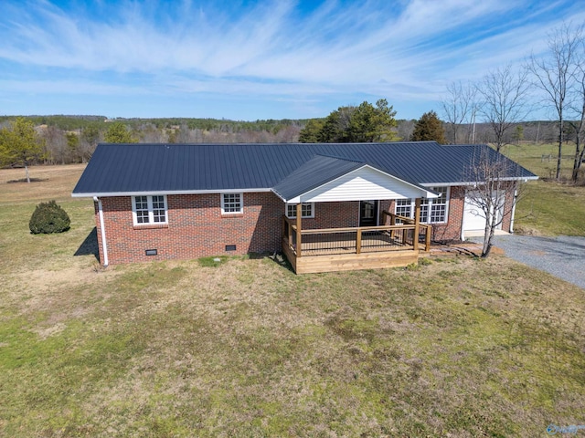 exterior space featuring crawl space, brick siding, a front yard, and metal roof