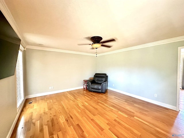 unfurnished room with baseboards, crown molding, and light wood finished floors