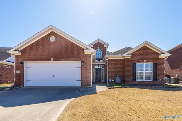 traditional home with brick siding, an attached garage, and driveway