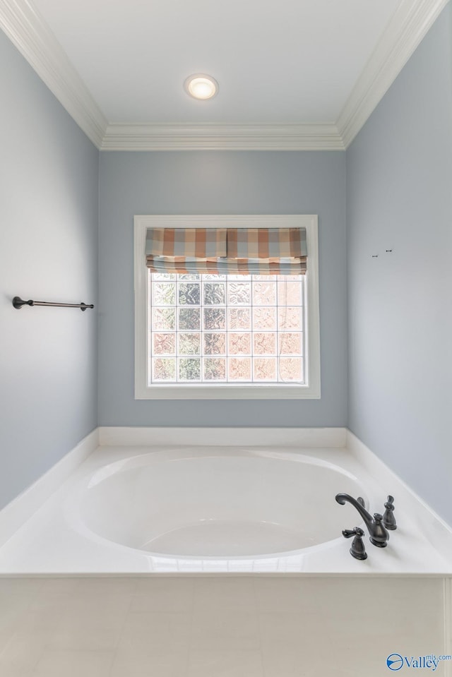 bathroom with crown molding and a bath