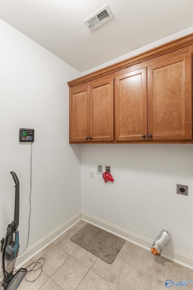 clothes washing area featuring visible vents, baseboards, washer hookup, cabinet space, and electric dryer hookup