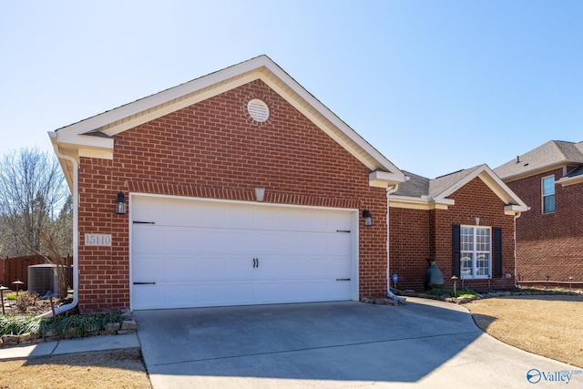 view of front of home with brick siding, cooling unit, driveway, and an attached garage