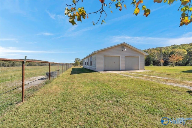 view of property exterior featuring an outdoor structure, a lawn, and a garage