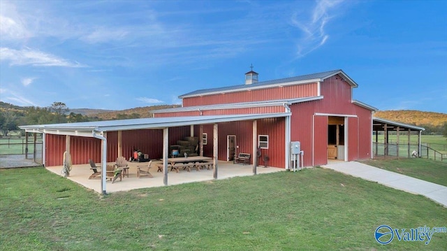 rear view of house with an outdoor structure and a yard