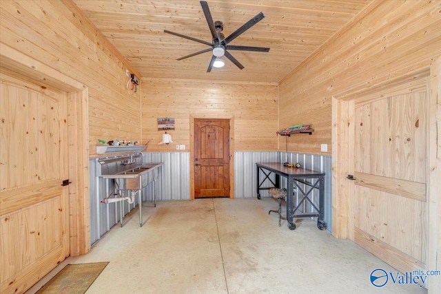 misc room with wooden walls, wood ceiling, and ceiling fan