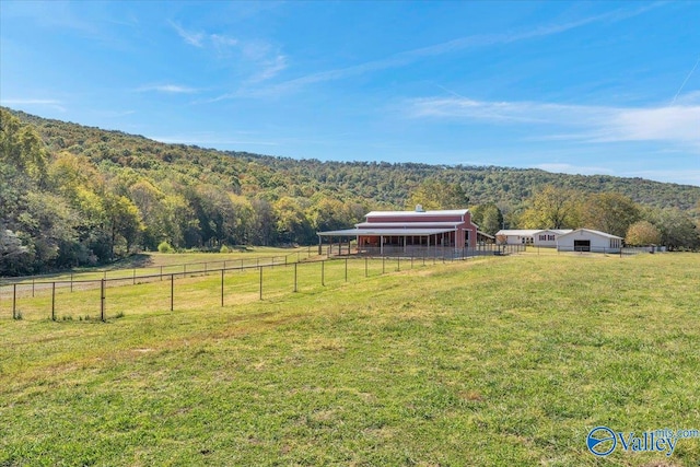 view of yard with a mountain view and a rural view