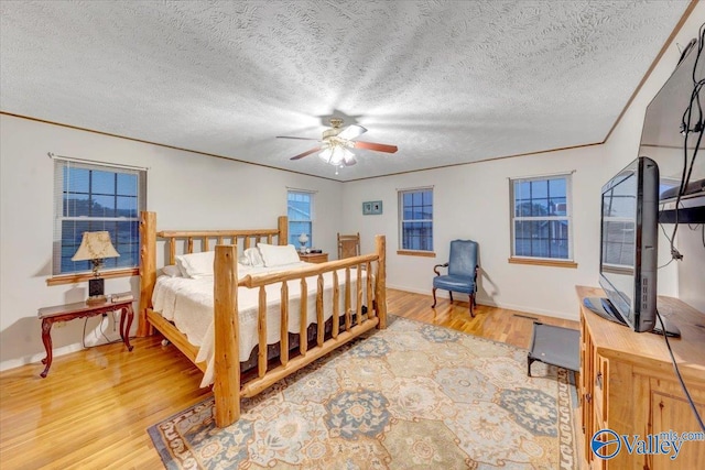 bedroom featuring a textured ceiling, hardwood / wood-style flooring, and ceiling fan