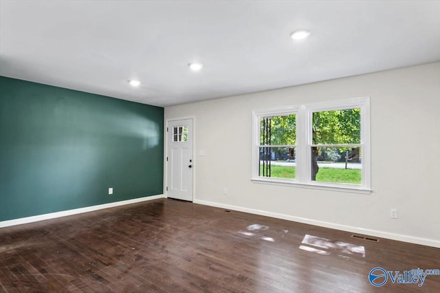 empty room featuring dark wood-type flooring