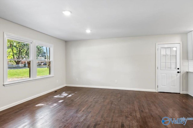 spare room featuring dark wood-type flooring