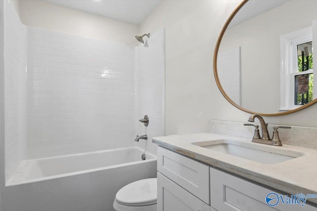 full bathroom with vanity, tiled shower / bath combo, and toilet