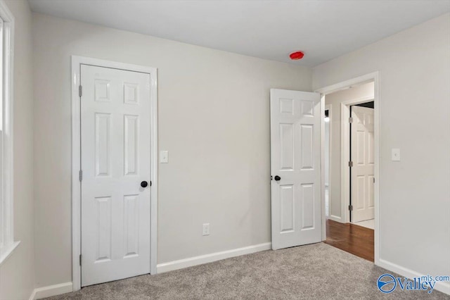 unfurnished bedroom with light colored carpet