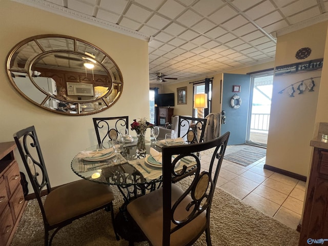 dining area featuring light tile patterned floors and ceiling fan