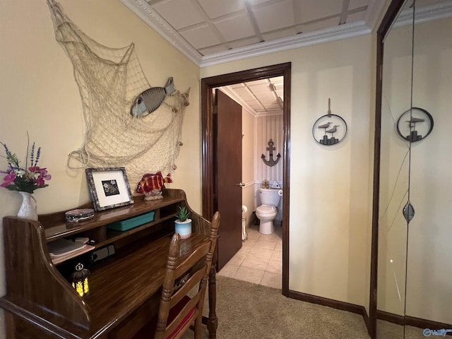 hall with ornamental molding and light carpet