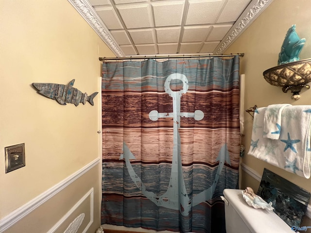 bathroom featuring a drop ceiling and a shower with curtain