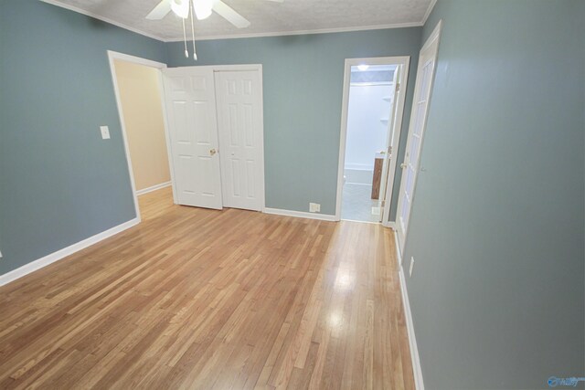 bedroom featuring ornamental molding, a textured ceiling, ceiling fan, hardwood / wood-style floors, and a closet