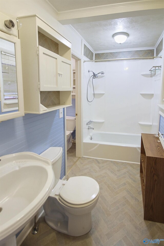 bathroom featuring sink, crown molding, and a textured ceiling