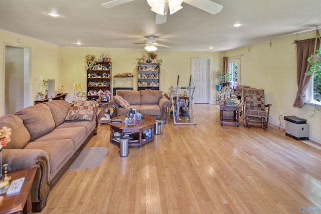 living room with ceiling fan and light hardwood / wood-style flooring