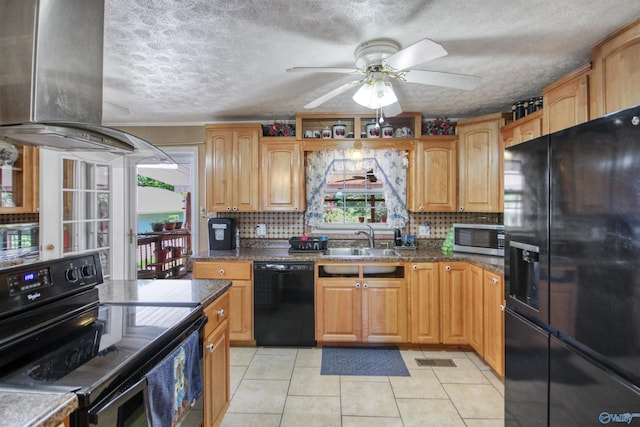 kitchen featuring black appliances, a healthy amount of sunlight, sink, and extractor fan