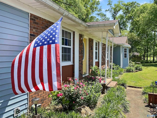 view of side of home with a yard