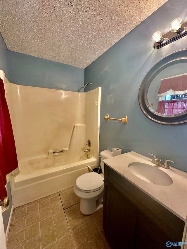 full bathroom with tile patterned flooring, a textured ceiling, shower / tub combo with curtain, vanity, and toilet