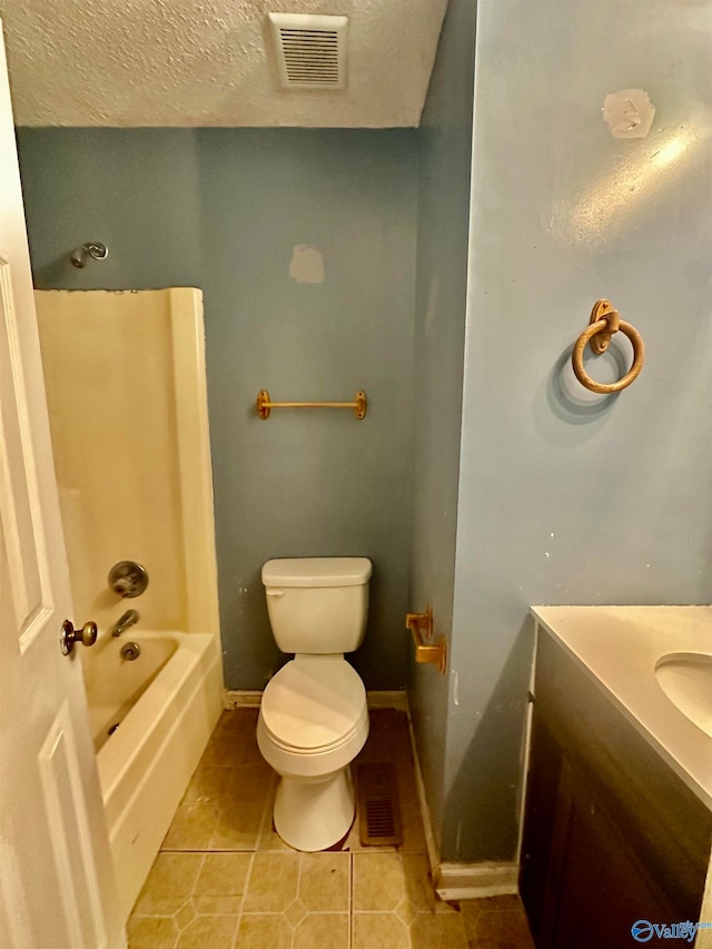 full bathroom featuring tile patterned flooring, a textured ceiling, shower / bath combination, vanity, and toilet