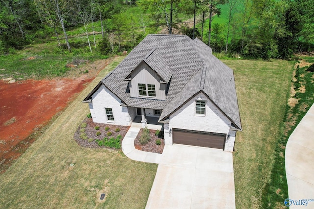 view of front of property with a garage and a front lawn