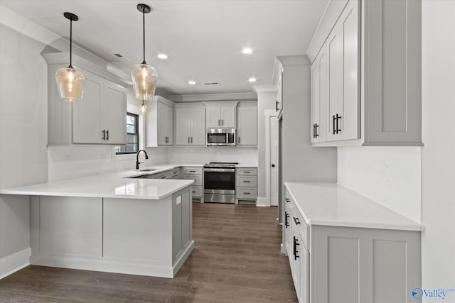 kitchen featuring range, tasteful backsplash, kitchen peninsula, decorative light fixtures, and dark hardwood / wood-style floors