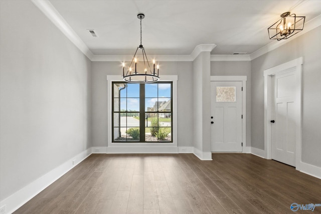 foyer with crown molding, a chandelier, and hardwood / wood-style floors