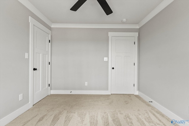 unfurnished bedroom featuring ornamental molding, light carpet, and ceiling fan