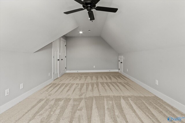 bonus room with light colored carpet, vaulted ceiling, and ceiling fan