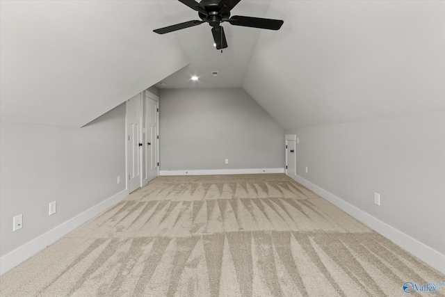 additional living space featuring vaulted ceiling, light colored carpet, and ceiling fan