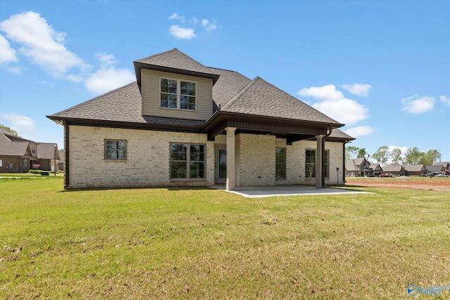 back of house featuring a patio area and a lawn