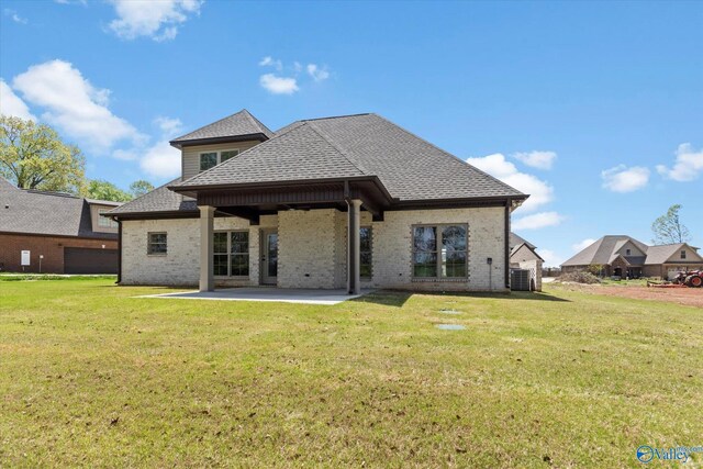 rear view of property with a patio area and a yard