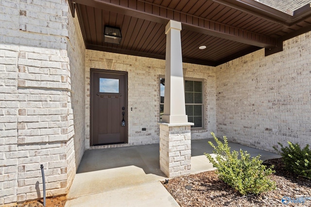 view of exterior entry featuring a porch