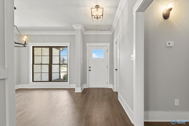 entrance foyer featuring crown molding, a notable chandelier, and dark hardwood / wood-style flooring