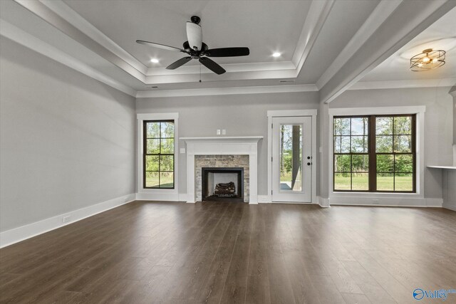 unfurnished living room featuring dark hardwood / wood-style floors, a healthy amount of sunlight, and ceiling fan