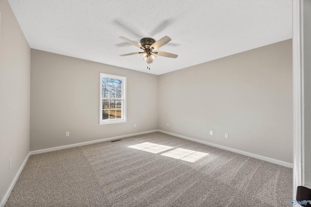 carpeted empty room featuring a textured ceiling and ceiling fan