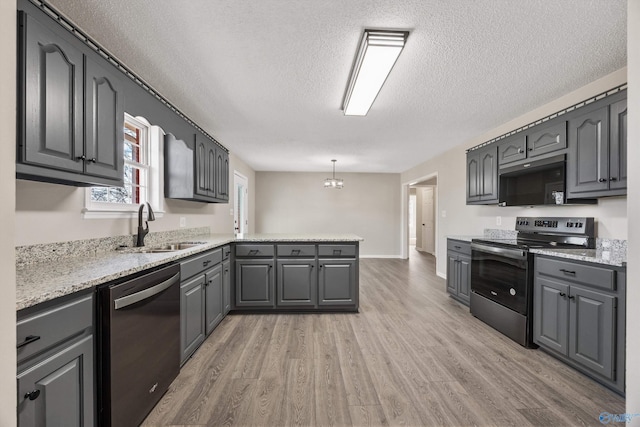 kitchen featuring stainless steel electric stove, dishwasher, decorative light fixtures, sink, and gray cabinetry