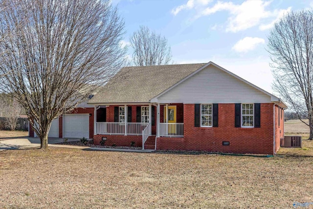 ranch-style house featuring covered porch, a front yard, central air condition unit, and a garage