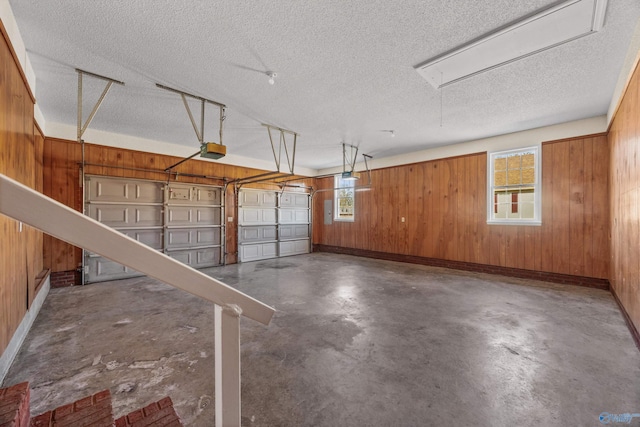 garage featuring wooden walls and a garage door opener