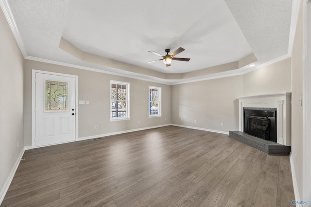 unfurnished living room featuring hardwood / wood-style flooring and a raised ceiling